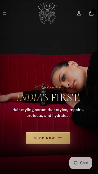UKEE website on a phone: a model resting on a red velvet sofa beside the serum bottle, with the headline India's first and a Shop now button.